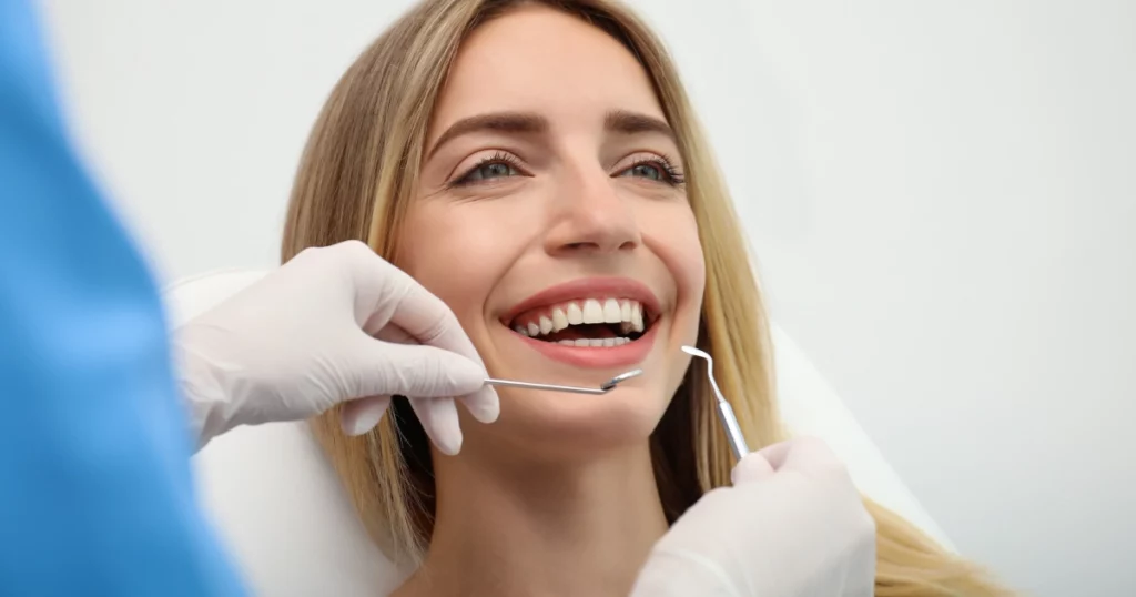 Cosmetic Dentistry for the Appearance of Your Overall Smile 1 A smiling woman receiving a dental checkup as part of Cosmetic Dentistry in Plano, TX.