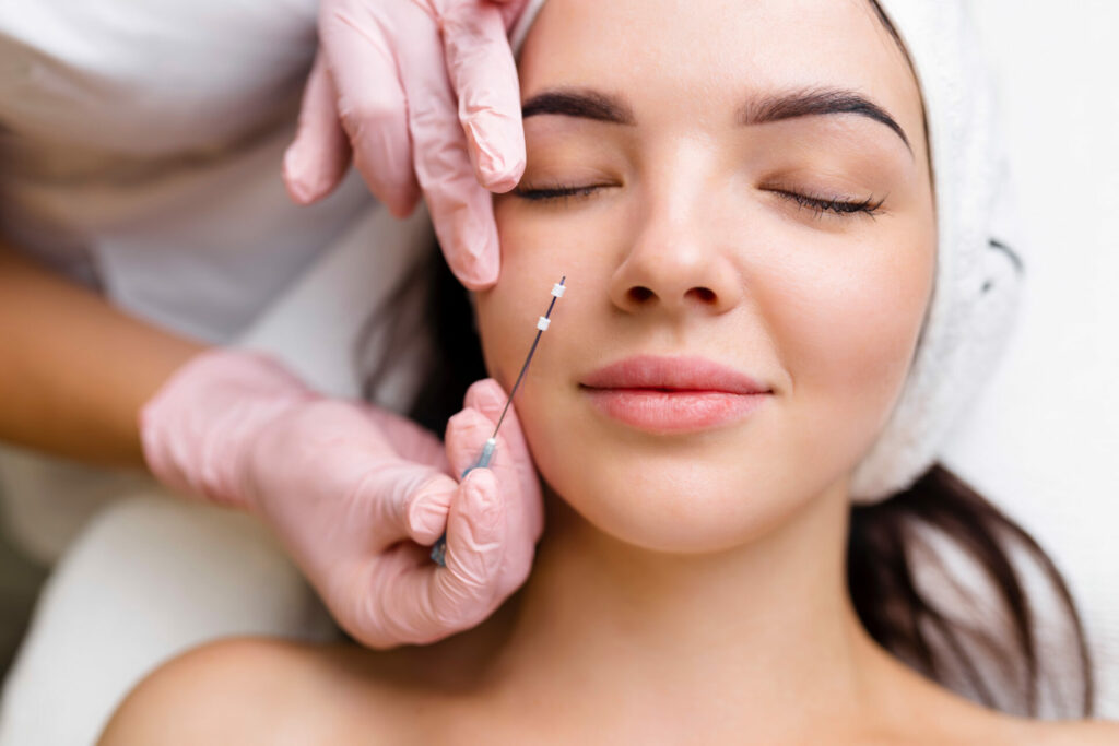 Comprehensive Guide to PDO Threads Cost and What to Expect Today 1 Patient receiving a PDO thread lift treatment on their face by a cosmetologist in Plano, TX.